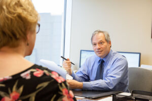 lawyer talking to a client about a workers compensation claim